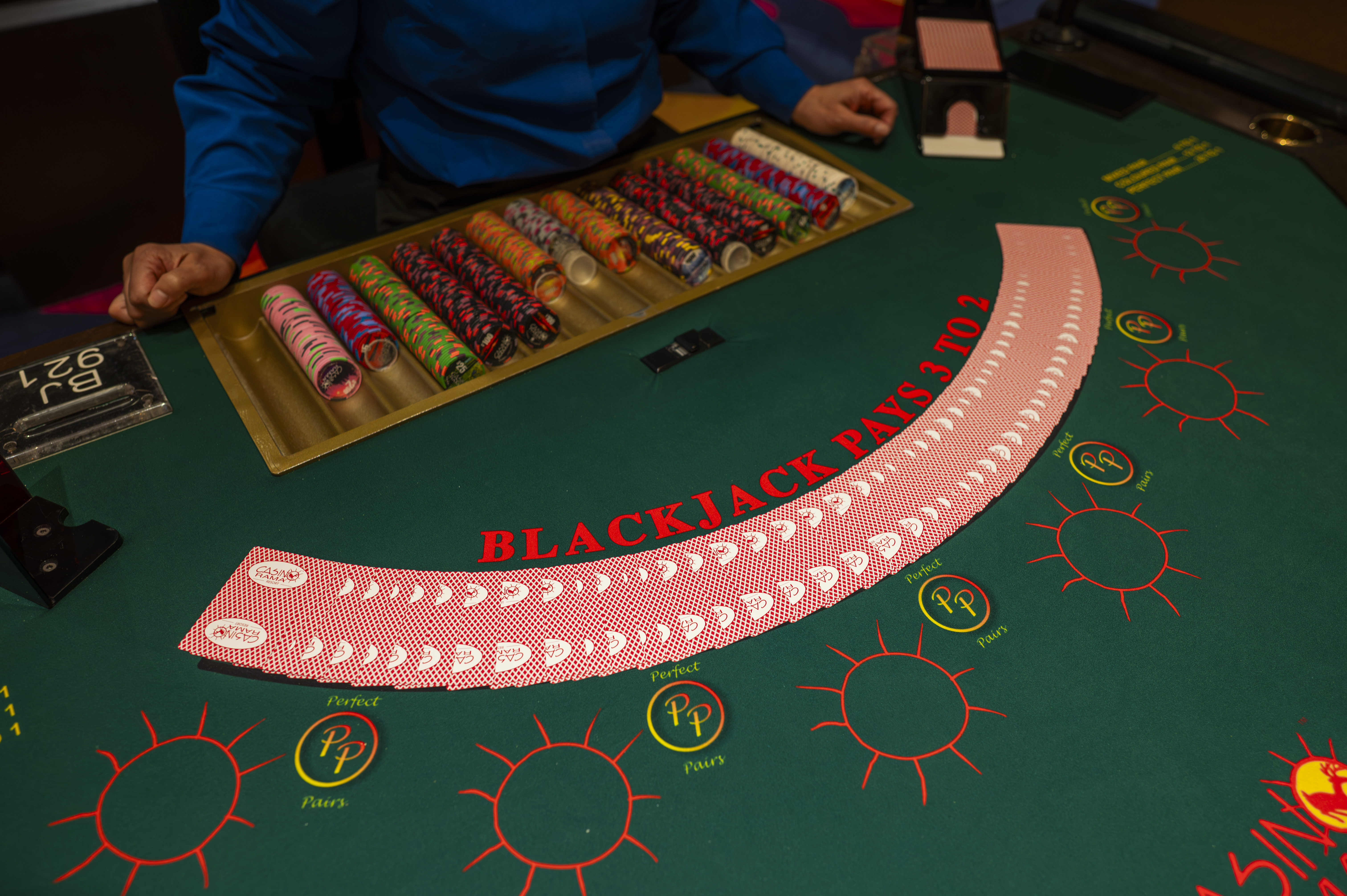 Casino Rama Resort blackjack table with cards, chips, and a dealer in a blue shirt
