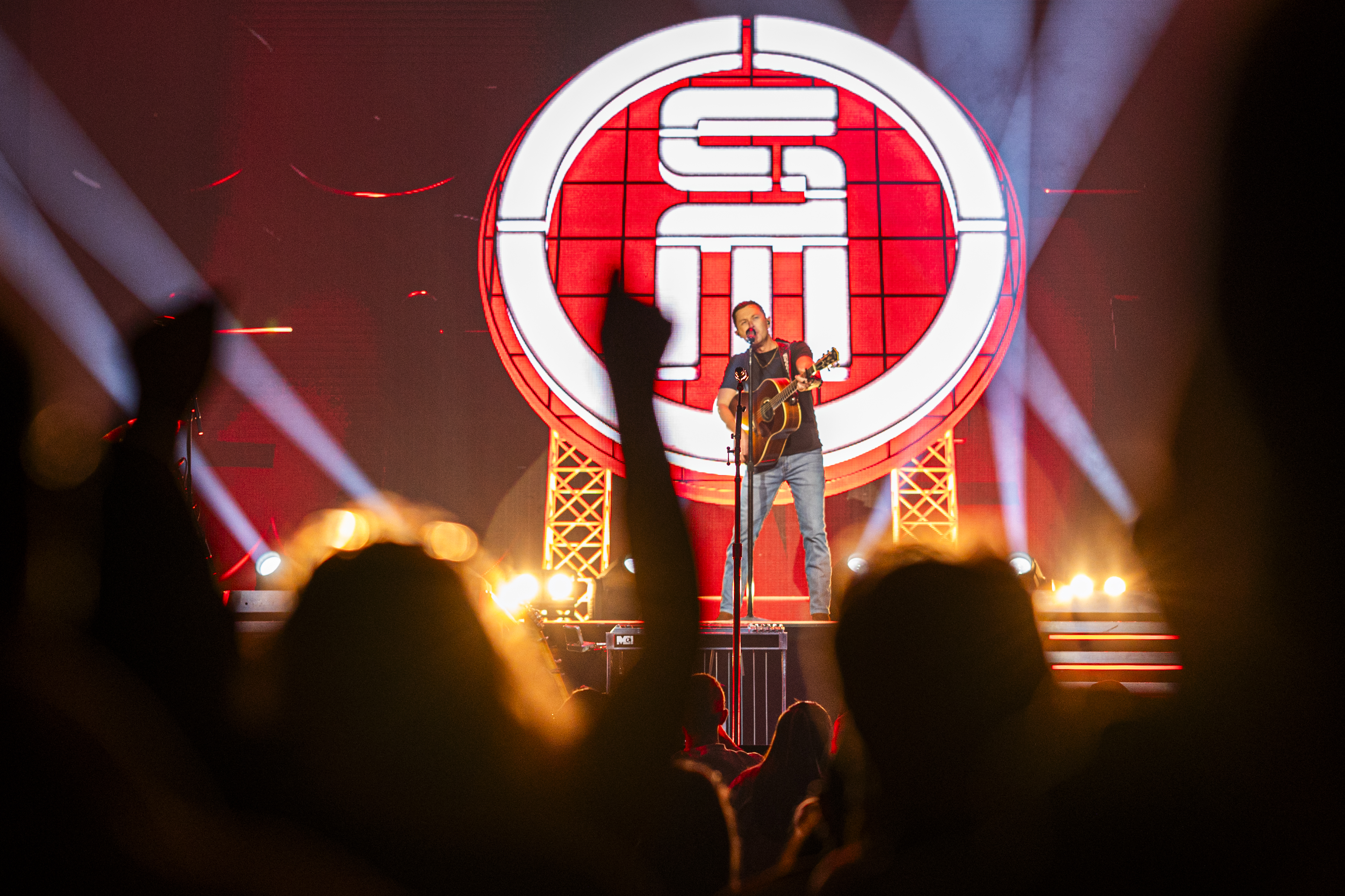 Scotty McCreery performs on stage at Casino Rama Resort, illuminated by bright stage lights
