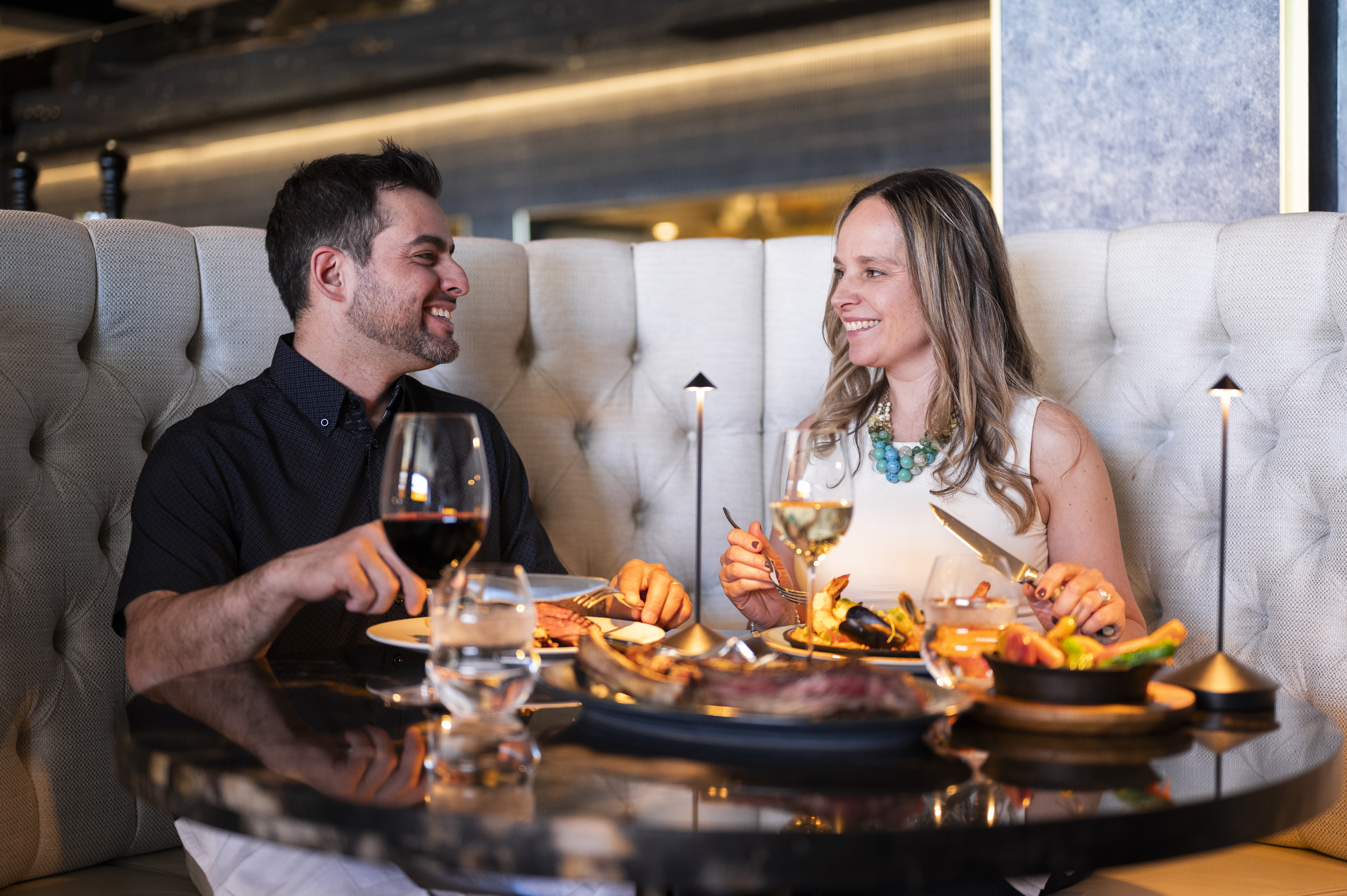 Couple smiling at each other while dining at a fine restaurant at Casino Rama Resort