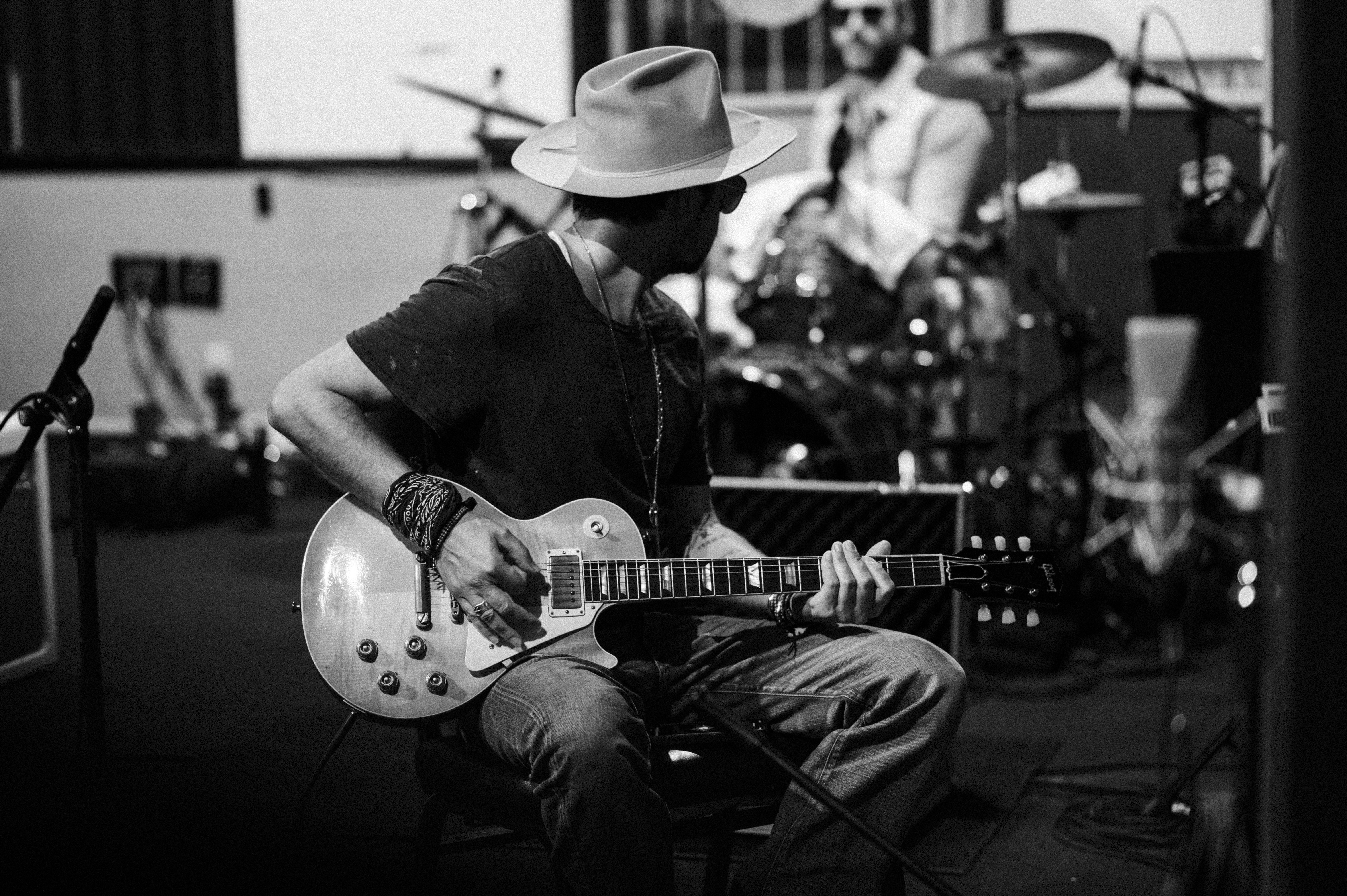 Black and white of Sons of Legion guitarist playing electric guitar in recording studio