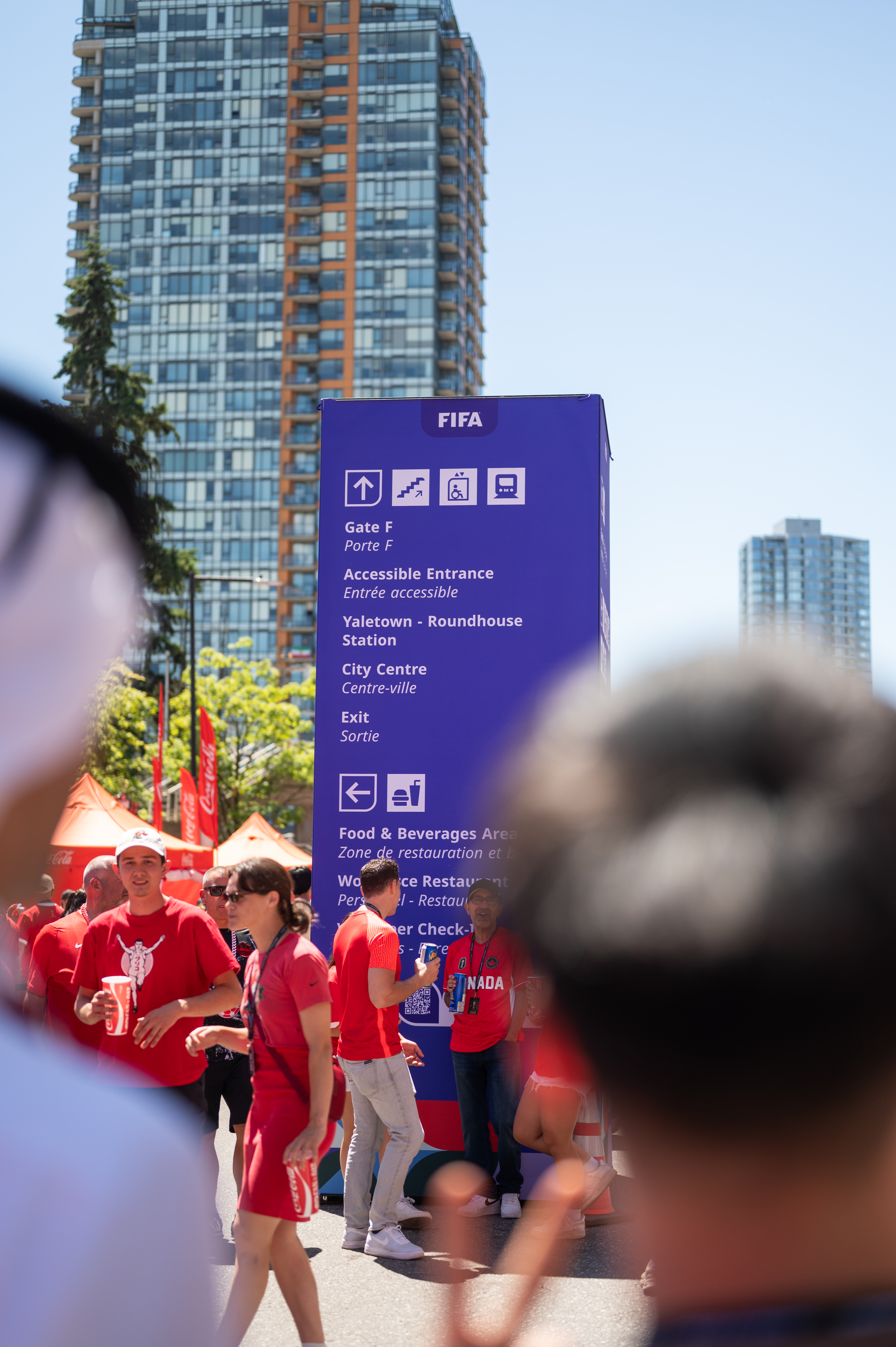 FIFA World Cup wayfinding sign in purple against a city skyline