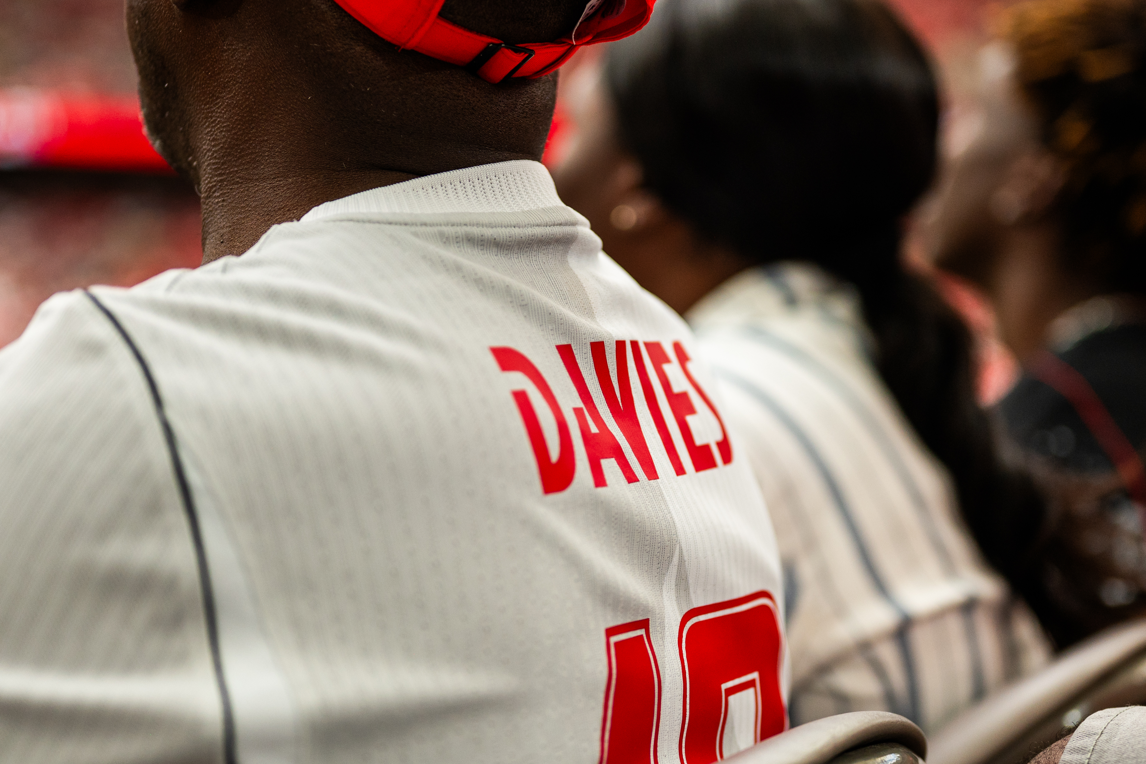 Back of fan wearing white "DAVIES" jersey with red text at a World Cup event