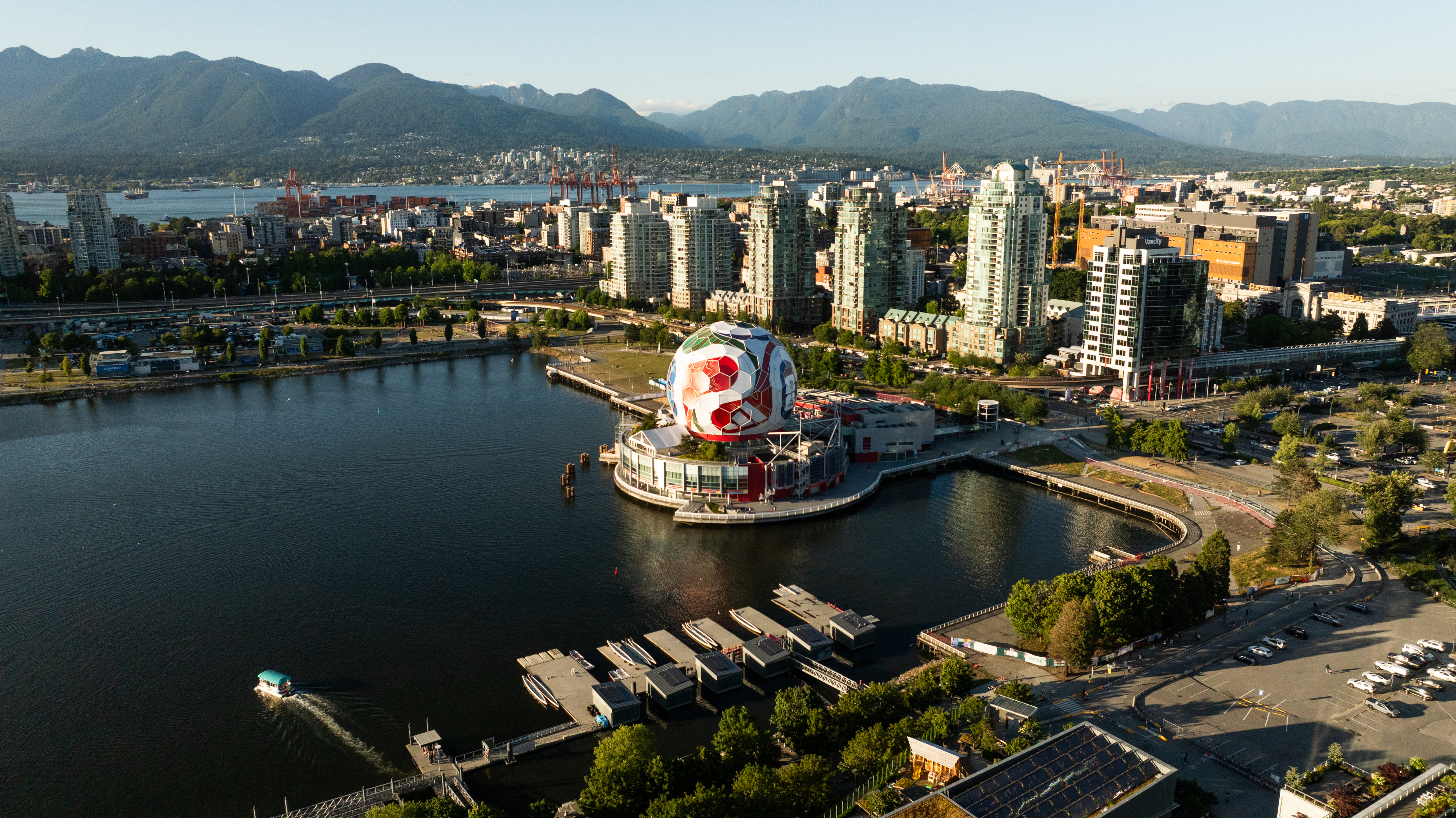 Aerial view of Vancouver city skyline with a large soccer ball structure by the water