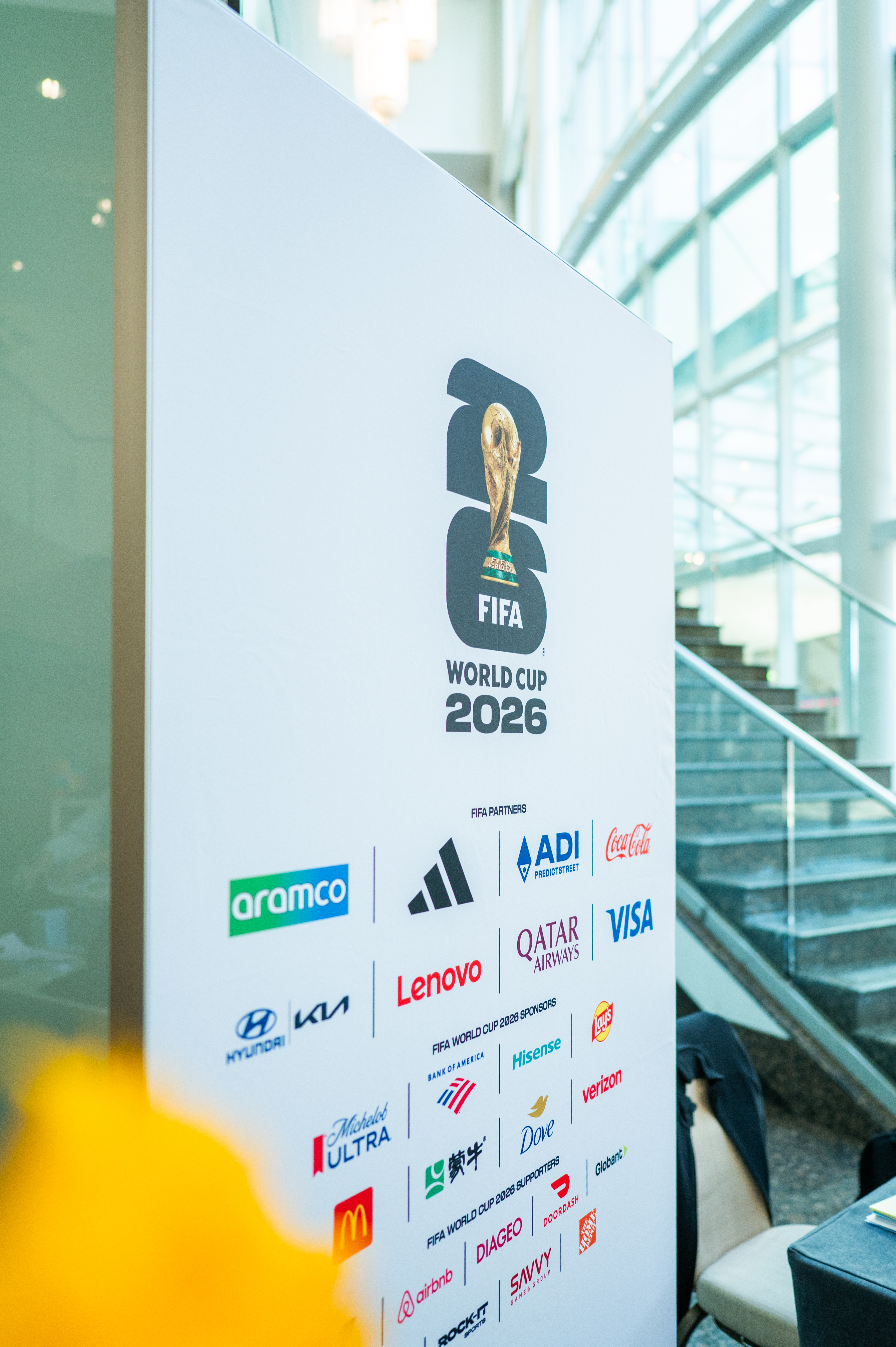 FIFA World Cup 2026 branding and sponsor logos on a large white banner