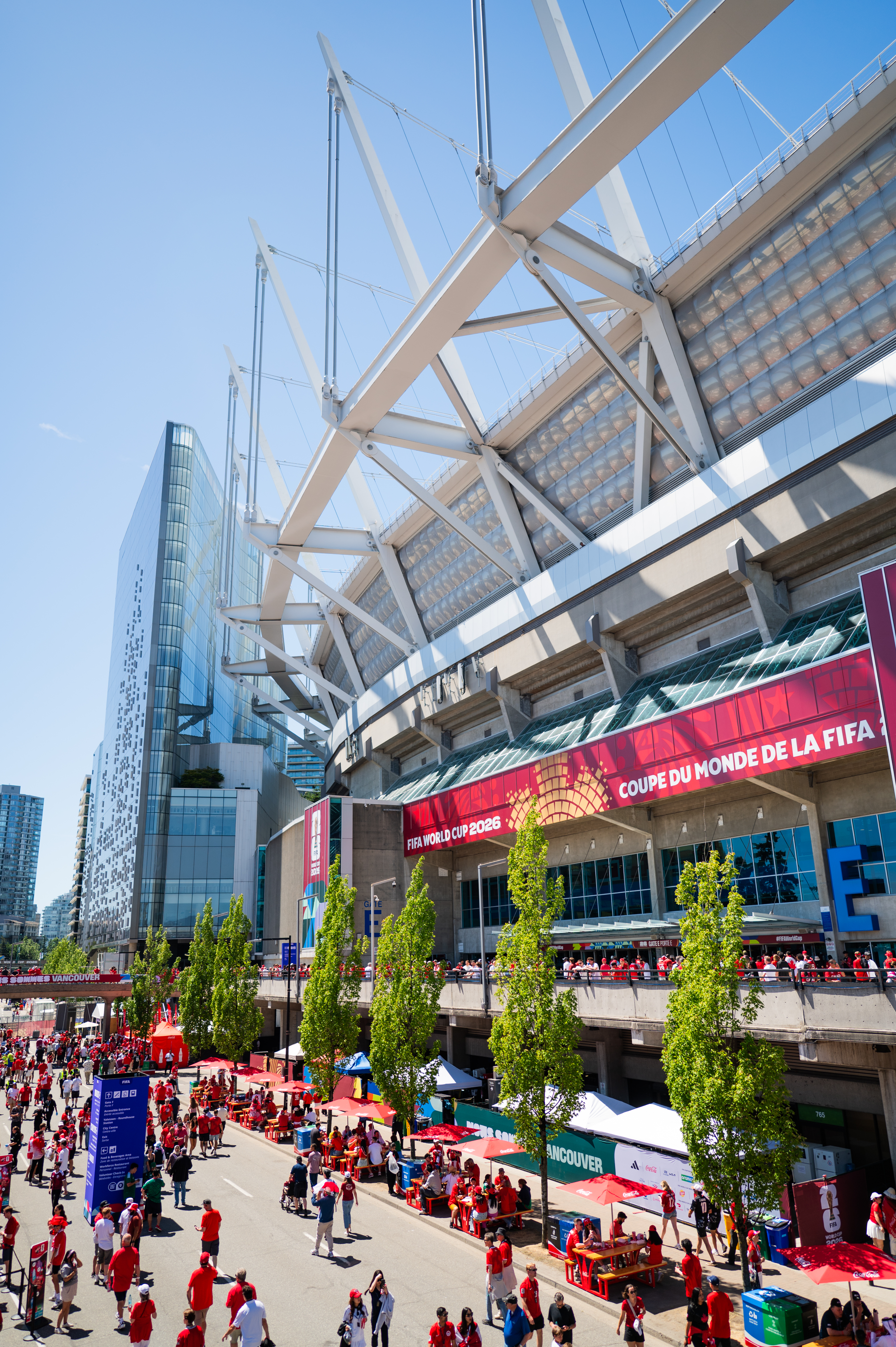 FIFA World Cup 2026 stadium with large banner, crowds, and branded city elements