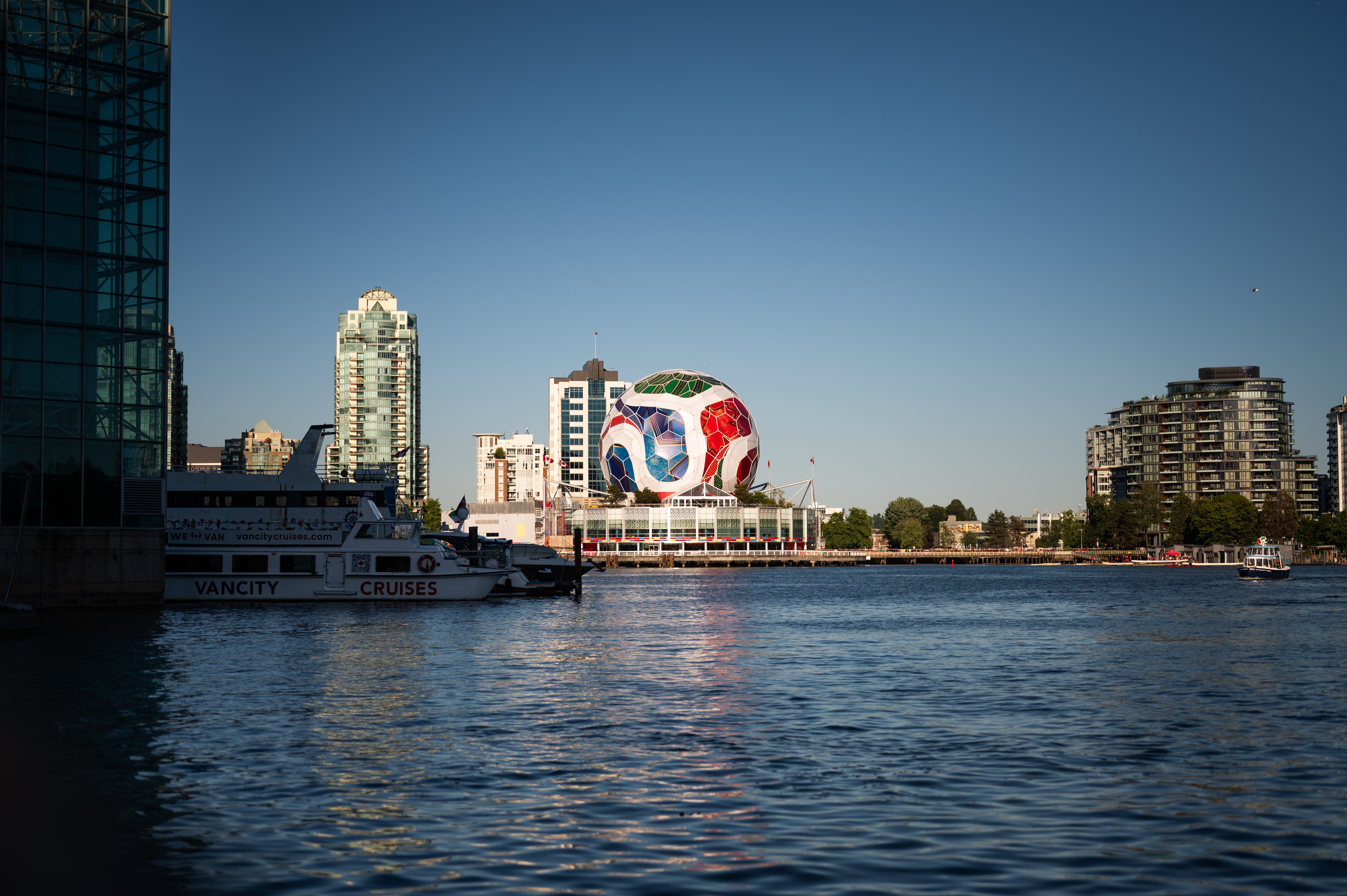 World Cup branded soccer ball structure and city skyline reflected in calm water