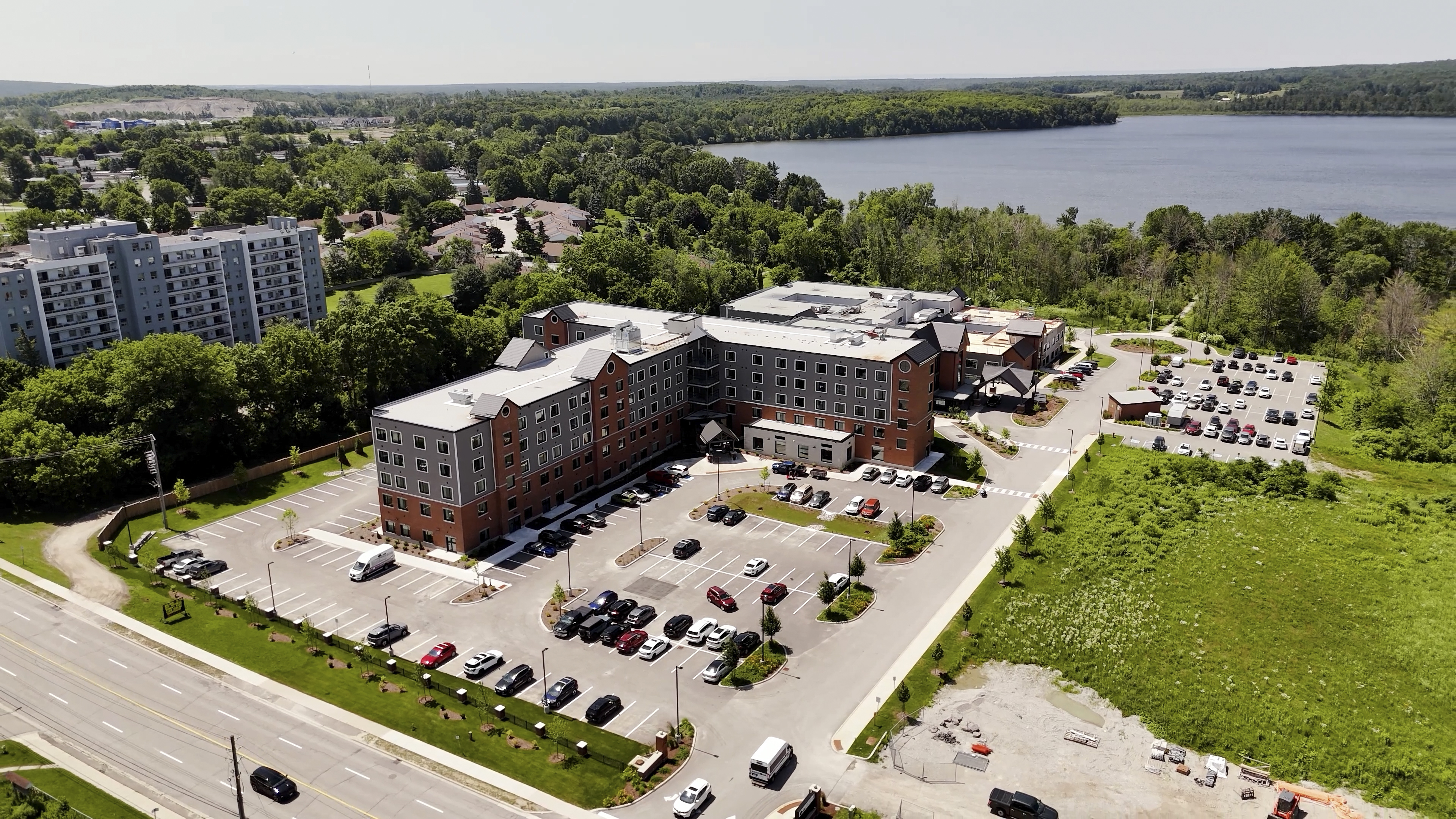 Aerial view of a modern Jarlette Health Services facility next to a lake